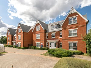 Brick building with white windows and hedges exterior at Parham Student Village in Canterbury Student Accommodation