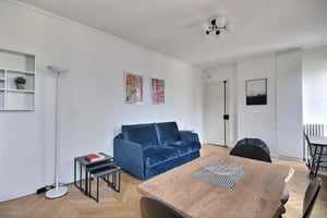 Blue sofa nesting tables modern lamp living room at Studio in Rue la Bruyère, 75009 Paris, France in Paris Student Accommodation
