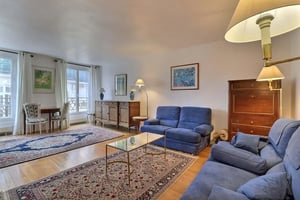 Blue sofas glass table antique cabinet living room at Apartment in Rue de la Lune, 75002 Paris, France in Paris Student Accommodation