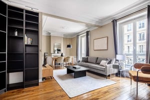 Bookshelf sofa dining table living room at Apartment in 29 Rue Monge, 75005 Paris, France in Paris Student Accommodation