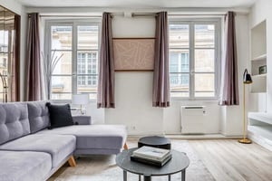 Purple curtains floor lamp grey sofa living room at Apartment in 1 Rue Monsieur le Prince, 75006 Paris, France in Paris Student Accommodation