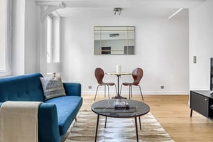 Blue sofa dining table and chairs living room at Apartment in 22 Rue des Carmes, 75005 Paris, France in Paris Student Accommodation
