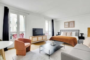 Bed TV armchair coffee table living room at Apartment in 47 Rue Cler, 75007 Paris, France in Paris Student Accommodation