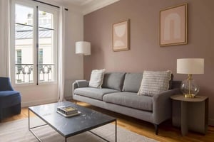 Grey sofa coffee table and artwork Living room at Apartment in 9 Imp. d'Antin, 75008 Paris, France in Paris Student Accommodation