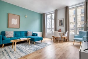 Turquoise sofa coffee table rug dining table living room at Apartment in 4 Rue Réaumur, 75003 Paris, France in Paris Student Accommodation