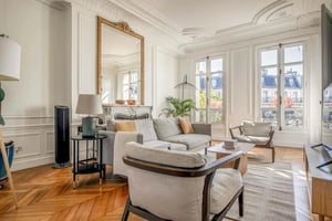 Sofa chairs coffee table fireplace large mirror living room at Apartment in 43 Bd Henri IV, 75004 Paris, France in Paris Student Accommodation