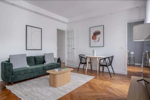 Green sofa coffee table and dining set living room at Apartment in 18 Rue Mesnil, 75016 Paris, France in Paris Student Accommodation