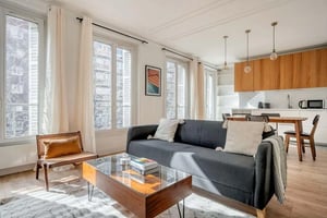 Sofa coffee table chairs and kitchen living room at Apartment in 182 Av. de Clichy, 75017 Paris, France in Paris Student Accommodation