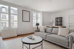 Grey sofa white table art with windows living room at Apartment in 48 Rue Beaubourg, 75003 Paris, France in Paris Student Accommodation