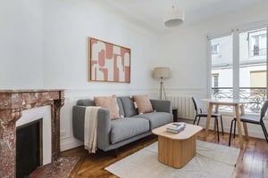 Gray sofa marble fireplace modern art living room at Apartment in 61 Rue Falguière, 75015 Paris, France in Paris Student Accommodation