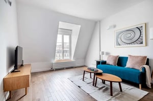 Blue sofa wooden tables artwork living room at Apartment in 16 Rue de l'Assomption, 75016 Paris, France in Paris Student Accommodation