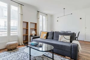Sofa bookshelves coffee table rug ottoman living room at Apartment in 23 Rue Léon Jost, 75017 Paris, France in Paris Student Accommodation