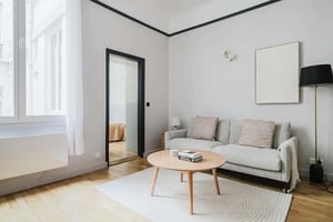 Sofa coffee table rug painting floor lamp living room at Apartment in 58 Rue de Verneuil, 75007 Paris, France in Paris Student Accommodation