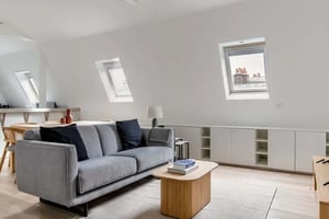 Grey sofa with pillows coffee table white cabinets living room at Apartment in 83 Av. Foch, 75016 Paris, France in Paris Student Accommodation