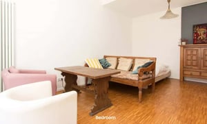 Wooden table with chairs and sofa bed Bedroom at Studio in Gürtelstraße, 10247 Berlin-Bezirk Friedrichshain-Kreuzberg, Germany in Berlin Student Accommodation