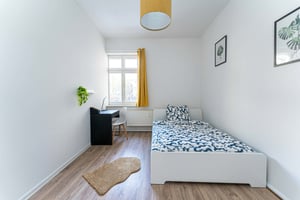 Bed desk chair plants and rug bedroom at Room in Silberberger Str., 12489 Berlin-Bezirk Treptow-Köpenick, Germany in Berlin Student Accommodation