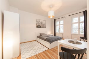 Bed, table, chairs, wardrobe, rug, bedroom at Studio in Karl-Marx-Straße, 12043 Berlin-Bezirk Neukölln, Germany in Berlin Student Accommodation
