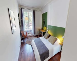 Bed pillows wardrobe table and mirror bedroom at Chambre dans le rue de Tilsitt in Paris Student Accommodation