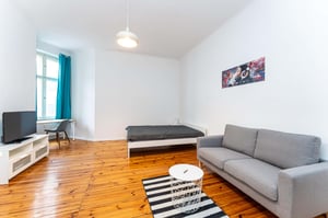 Bed sofa television and desk living room at Studio in Bornholmer Str. 17, 10439 Berlin, Germany in Berlin Student Accommodation