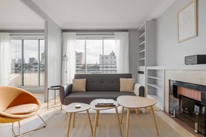 Sofa two pillows coffee tables armchair living room at Apartment in 5 Rue Léon Bonnat, 75016 Paris, France in Paris Student Accommodation