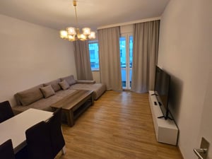 Sectional couch coffee table dining table and TV living room at Apartment in Albrecht-Achilles-Straße 6, 10709 Berlin-Bezirk Charlottenburg-Wilmersdorf, Deutschland in Berlin Student Accommodation
