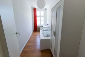 White bed with patterned bedding wardrobe wooden floor bedroom at Room in Hermannstraße, 12049 Berlin, Germany in Berlin Student Accommodation