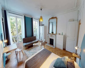 Bed fireplace desk and mirror bedroom at Room in 29 Bd de Magenta, 75010 Paris, France in Paris Student Accommodation
