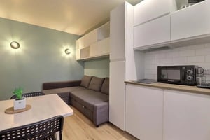 Sofa dining table microwave kitchen living area at Studio in Rue Richard Lenoir, 75011 Paris, France in Paris Student Accommodation