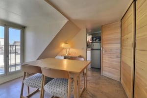 Table chairs lamp refrigerator kitchen area living room at Apartment in Rue Rambuteau, 75001 Paris, France in Paris Student Accommodation