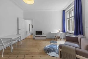 Sofa desk table and tv living room at Gabriel-Max-Straße - Studio Apartment in Berlin Student Accommodation
