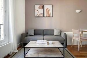 Gray sofa coffee table artwork wall lamp living room at Avenue Beaucour in Paris Student Accommodation