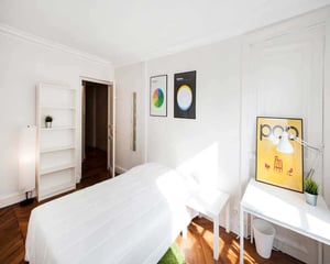 Bed shelf desk lamp posters bedroom at Chambre dans le Rue Rambuteau in Paris Student Accommodation