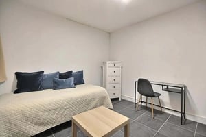 Bed dresser desk chair table bedroom at Studio in Rue le Regrattier, 75004 Paris, France in Paris Student Accommodation