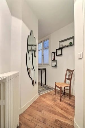 Wooden floor chair mirror shelves window hallway at Apartment 2 bedrooms 78m² in Paris Student Accommodation