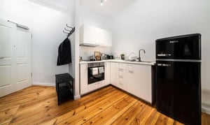 Black fridge cabinets sink oven and bench kitchen at 2-bedroom apartment for rent in Berlin, bills included in Berlin Student Accommodation