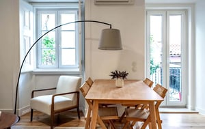 Wooden dining table with chairs and chair Living area at 2 bedroom Apartment fully renovated in Lapa in Lisbon Student Accommodation
