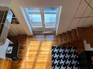 Wooden stairs rug near air conditioner living area at Friendly apartment in Lisbon in Lisbon Student Accommodation