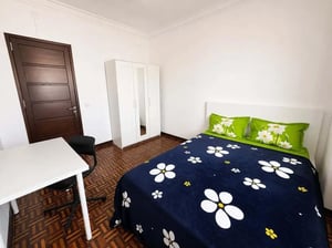 Bed desk closet and door bedroom at Spacious room in Lisbon City Center in Lisbon Student Accommodation