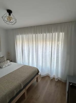 Bed with patterned pillows and bedside lamp bedroom at Renovated 2-bedroom duplex with river view in Beato, Lisbon  (SEP-MAY Only) in Lisbon Student Accommodation