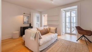 Sofa rug chair and balcony doors living room at Downtown Cozy 1BDR Apartment in Lisbon Student Accommodation