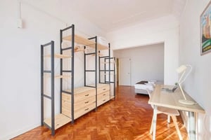 Closet with drawers desk with laptop bedroom living room at PR11#R1 - Bedroom w/ balcony in Príncipe Real in Lisbon Student Accommodation