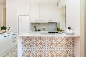 White cabinets patterned tiles stovetop and kettle kitchen at Apartment in Rua de Moçambique, Lisboa in Lisbon Student Accommodation