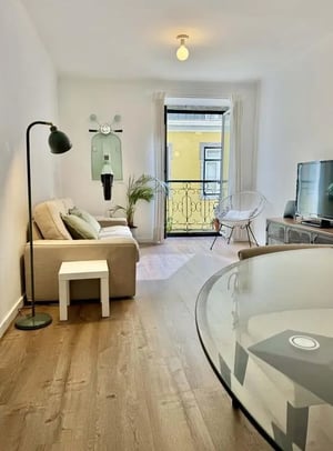 Sofa lamp plant TV glass table living room at Apartment with 135 m² close to Lisbon City Centre in Lisbon Student Accommodation