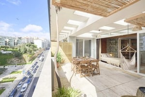 Dining set hammock bed with city view balcony exterior at Modern Studio in Avenida Infante Santo, Lisbon in Lisbon Student Accommodation