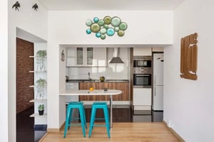 Modern kitchen with breakfast bar and turquoise stools kitchen at Rua Marcos Portugal in Lisbon Student Accommodation