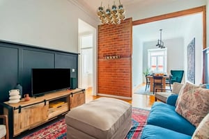 Television ottoman blue sofa and dining area Living room at Graça's Urban Elegance in Lisbon Student Accommodation