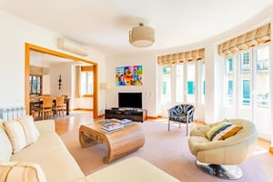Sofa coffee table television chairs and dining area living room at Avenida Praia da Vitória in Lisbon Student Accommodation