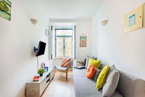 Sofa chair TV and table living room at Rua Marques da Silva in Lisbon Student Accommodation