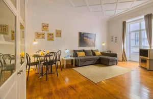 Dining table sofa rug and vintage television living room at Rua da Horta Sêca in Lisbon Student Accommodation
