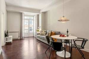 Sofa dining table with cakes wine living room. at Chiado Urban Stay in Lisbon Student Accommodation